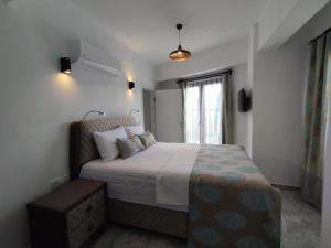 a bedroom with a large bed in a room at Gokceada Marmaros Butik Otel in Gokceada Town