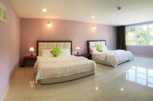 Vuode tai vuoteita majoituspaikassa Hilltop Hotel Tanjung Malim