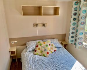 a bedroom with a bed with a blue comforter at Camping River in Le Martinet
