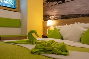 a green towel sitting on top of a bed at Castle Suite in Budapest