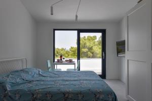a bedroom with a bed and a table and a window at Lazaneo Seafront Apartments, Jelsa Hvar in Jelsa +39 photos