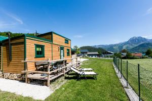 a wooden cabin with a picnic table and a fence at Reiter- und Feriengut Suassbauer in St. Wolfgang