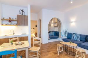 a living room with a blue couch and a table at FOULI'S HOUSE II in Agios Ioannis