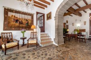 a living room with a staircase and a painting on the wall at Agroturismo Muleta de Ca S'hereu in Port de Soller