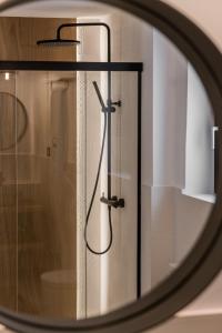a reflection of a shower in a mirror at Hotel Santo Crist La Ciudadela Marbella in Marbella