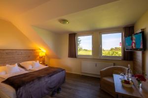 Postel nebo postele na pokoji v ubytování Hotel MeerLand Pellworm