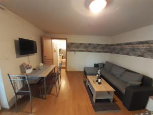 a living room with a couch and a table at Apartmán LauMar 2 in Bzenec