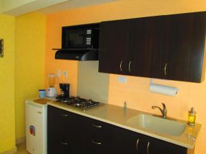 a kitchen with a sink and a stove at Haynes Cay View in San Andrés