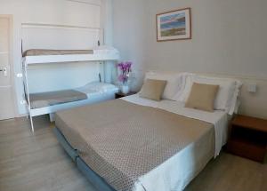 Postel nebo postele na pokoji v ubytování Hotel Caravel