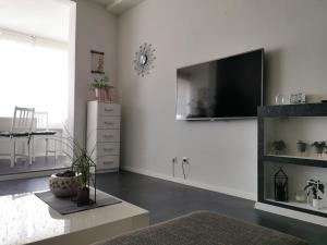 a living room with a flat screen tv on the wall at Apartment Orchidee in Pula