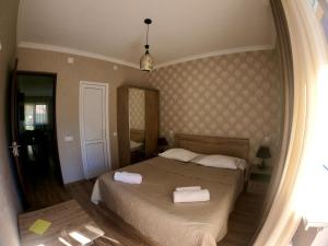 A bed or beds in a room at Kazbegi Inn