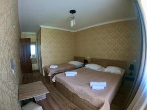 A bed or beds in a room at Kazbegi Inn