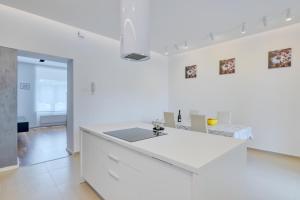 a white kitchen with a sink in a room at Apartment light in Pula in Pula