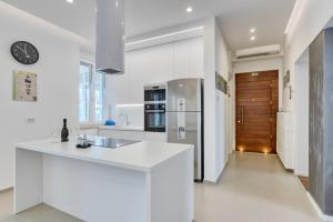 a kitchen with a white counter and a refrigerator at Apartment light in Pula in Pula