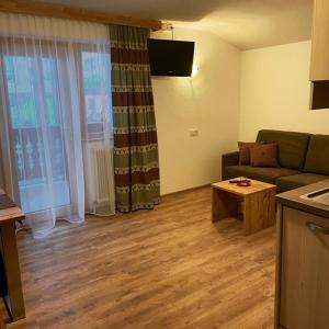 a living room with a couch and a table at Rimls Landhaus in Sölden