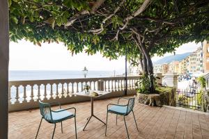 two chairs and a table on a balcony with the ocean at Sublimis Boutique Hotel Adults-Only in Camogli