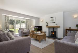 a living room with two couches and a fireplace at Little Tithe in Moreton in Marsh