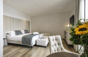 a bedroom with a bed and a table with a chair at Sublimis Boutique Hotel Adults-Only in Camogli