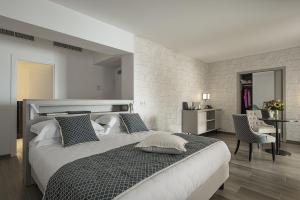 a bedroom with a large bed and a table and chairs at Sublimis Boutique Hotel Adults-Only in Camogli
