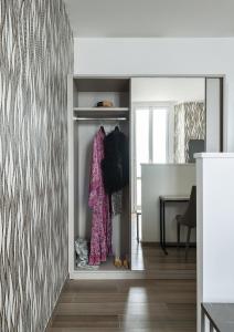 a walk in closet with a pink dress in it at Sublimis Boutique Hotel Adults-Only in Camogli