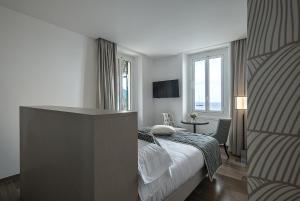 a hotel room with a bed and a window at Sublimis Boutique Hotel Adults-Only in Camogli