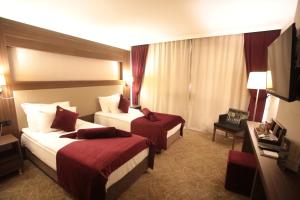 Postel nebo postele na pokoji v ubytování Paşapark Selçuklu Hotel