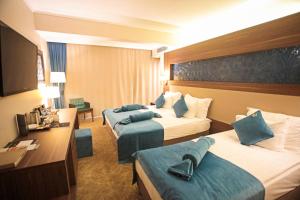 Postel nebo postele na pokoji v ubytování Paşapark Selçuklu Hotel