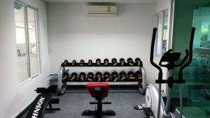 a room with a gym with a treadmill at The Dome Residence in Chiang Mai