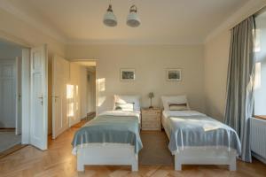 a bedroom with two beds and a window at Vila NMNM in Nové Město na Moravě