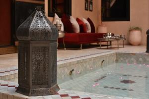a fire hydrant sitting in the middle of a pool of water at Riad Yacout in Meknès