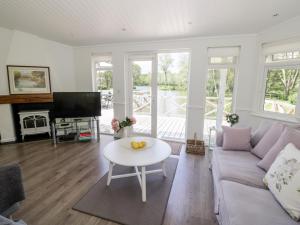 a living room with a couch and a table at Phocle Lodge in Ross on Wye