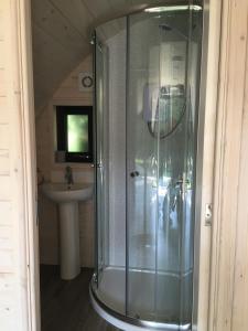a glass shower in a bathroom with a sink at Low Greenlands Holiday Park - Luxury House & Luxury Glamping Pods in Lancaster