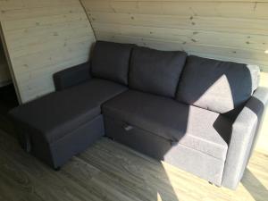 a couch sitting in the corner of a room at Low Greenlands Holiday Park - Luxury House & Luxury Glamping Pods in Lancaster