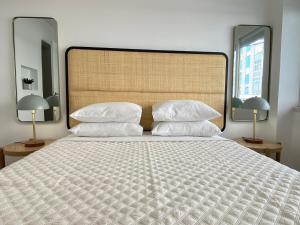 una camera da letto con un grande letto con due specchi di Project Montalvão a Setúbal