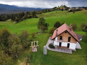 una vista aerea di una casa in un campo di Unique Cottage House With Panoramic View On Ravnik a Hotedršica