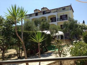 a building with palm trees in front of it at SeaView Apartments in Tsilivi