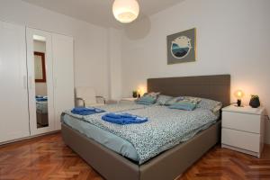a bedroom with a bed with blue towels on it at Sugar house in Pag