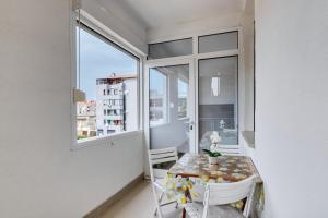 a small dining room with a table and a window at Apartment light in Pula in Pula