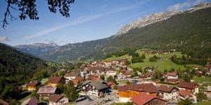 a town in a valley with mountains in the background at Hotel Les Aravis in Saint-Jean-de-Sixt