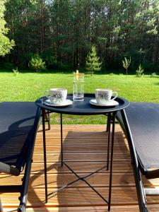 a blue table with two coffee cups on a deck at Neverland in Zelwa