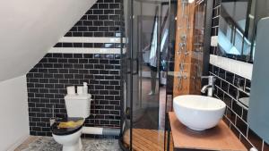 a bathroom with a white toilet and a sink at Chambre d'hote Le clos Valmont in Fécamp