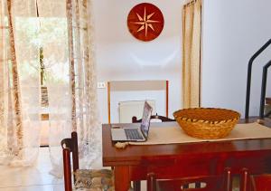 a laptop computer sitting on a table in a room at Casa Nanni - 50 mt dal mare in Stintino