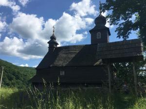 a church with a steeple on top of a hill at Глемпінг luxury in Lypovets
