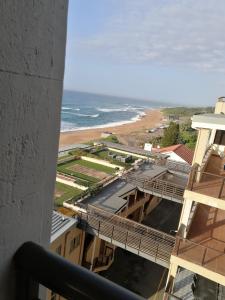 a view of the beach from the balcony of a building at norizana's apartment in Westbrook
