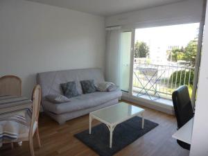 a living room with a couch and a table at Minerva in Anglet