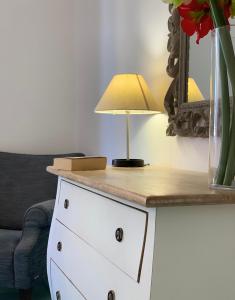 a table with a lamp on top of a dresser at Sorrento Moon in Sorrento