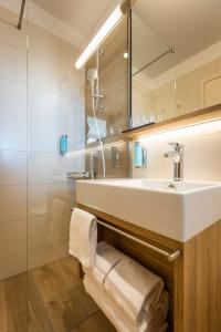 a bathroom with a towel rack and a sink at Hotel Histrion in Portorož