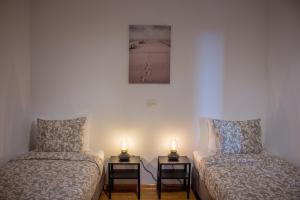 a room with two beds and two candles on tables at Seaview Heights above Portorož in Izola