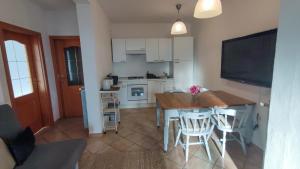 a kitchen with a table and chairs and a television at Seaview Heights above Portorož in Izola