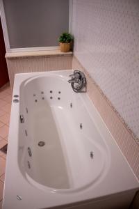 a large white bath tub in a bathroom at Seaview Heights above Portorož in Izola +21 photos